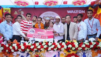 নজরুল ইসলামের হাতে ওয়ালটন ফ্রিজ কিনে পাওয়া ১০১টি ফ্রি পণ্য তুলে দেওয়া হচ্ছে।