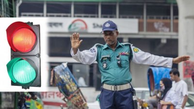সিগন্যাল নিয়ন্ত্রণে কাজ করছেন একজন ট্রাফিক পুলিশ সদস্য