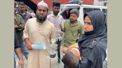 সন্তানকে নিয়ে শ্যামলীর বাংলাদেশ শিশু হাসপাতাল ও ইনস্টিটিউটের ইমার্জেন্সি বিভাগের সামনে শারমিন শিলা। ছবি: বাংলা ট্রিবিউন