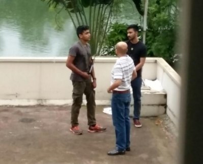 হলি আর্টিজানের ছাদে এক জঙ্গি এবং হাসনাত ও তাহমিদ (ছবি: সংগৃহীত)