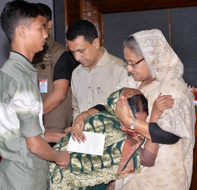 প্রধানমন্ত্রীর চেক পেয়ে তাকে জড়িয়ে ধরেন ক্ষতিগ্রস্ত পরিবারের একজন (ছবি: ফোকাস বাংলা)