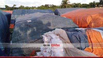 খোলা আকাশের নিচে ত্রিপলে ঢেকে রাখা সার (ছবি&ndash; প্রতিনিধি)