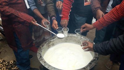 গাভি প্রতীকের প্রার্থী ভোটারদের পান করাচ্ছেন গরম দুধ