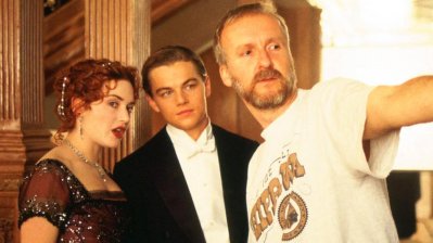 Two artists with producer James Cameron on set