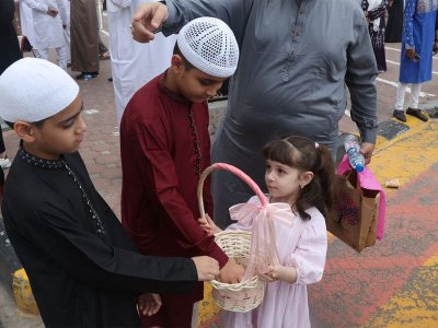 A child distributing sweets in Sharjah.  Photo: Gulf News