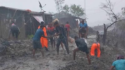 বেড়িবাঁধ উপচে প্রবশে করা পানি ঠেকানোর চেষ্টা গ্রামবাসীর