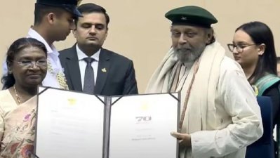 দ্রৌপদী মুর্মুর হাত থেকে পুরস্কার গ্রহণ করছেন মিঠুন চক্রবর্তী