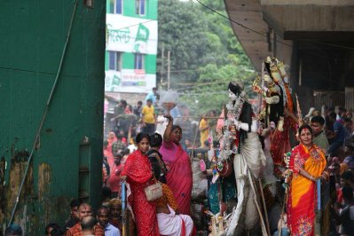 বৈরী আবহাওয়ার মধ্যেও বিসর্জন দেখতে বুড়িগঙ্গার পাড়ে মানুষের ঢল নামে (ছবি: বাংলা ট্রিবিউন)