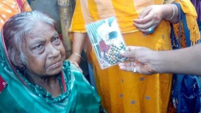 বাড়িতে আসার বৃদ্ধার সঙ্গে মৃত বছিরন বেওয়ার ছবি মিলিয়ে দেখাচ্ছেন এক স্বজন