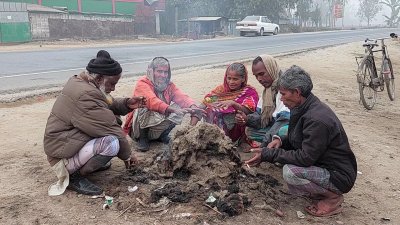 খড়কুটো জ্বালিয়ে শীত নিবারণের চেষ্টা