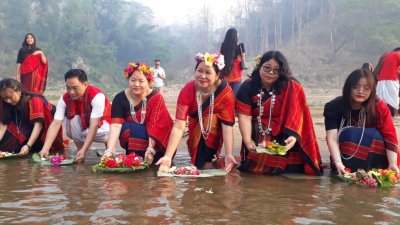 তরুণ-তরুণীরা সাঙ্গু নদীতে ফুল ভাসাচ্ছেন