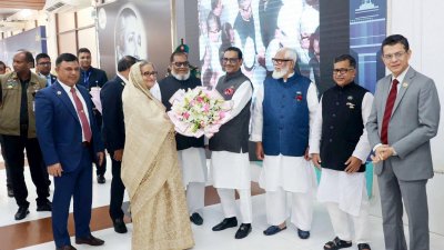 প্রধানমন্ত্রী শেখ হাসিনা বিমানবন্দরে পৌঁছালে তাকে ফুল দিয়ে স্বাগত জানান সড়ক পরিবহন ও সেতুমন্ত্রী ওবায়দুল কাদের  ছবি: ফোকাস বাংলা