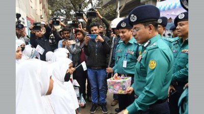 শিক্ষার্থীদের মাঝে চকলেট বিরতণ করছেন ডিএমপি কমিশনার হাবিবুর রহমান