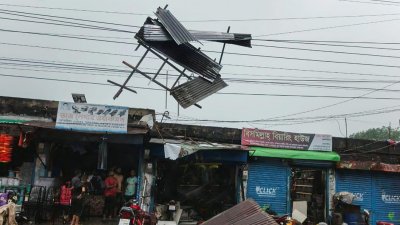 দোকানের টিনের চালা উড়ে গিয়ে বৈদ্যুতিক তারে ঝুলছে