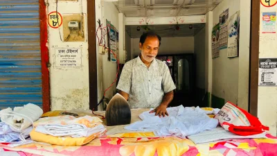 দিনে আয় অর্ধেকে নেমেছে বলে জানালেন নাটোরের লন্ড্রি দোকানি আজগর আলী