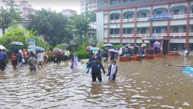 বৃষ্টির কারণে কেউ হাঁটু থেকে কোমরসমান পানি মাড়িয়ে, আবার কেউ নৌকায় করে পরীক্ষাকেন্দ্রে প্রবেশ করেছেন