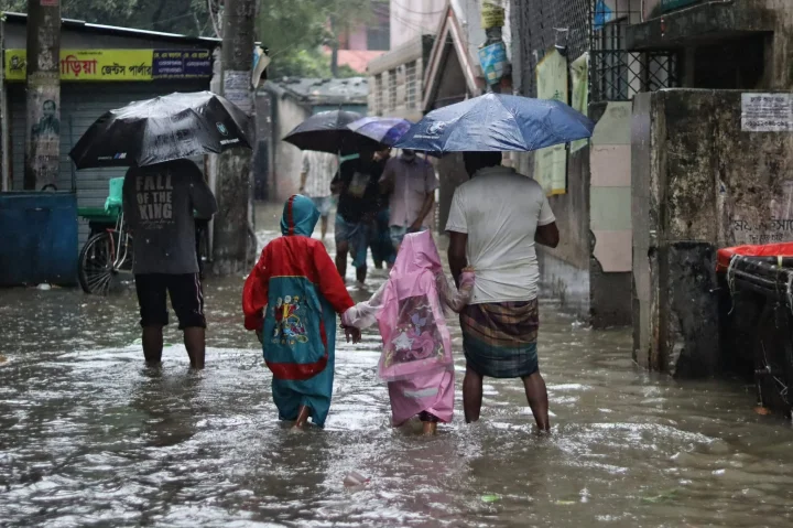 রাস্তায় জমে থাকা পানি মাড়িয়ে স্কুলগামী দুই শিশু শিক্ষার্থী, ছবি: নাসিরুল ইসলাম